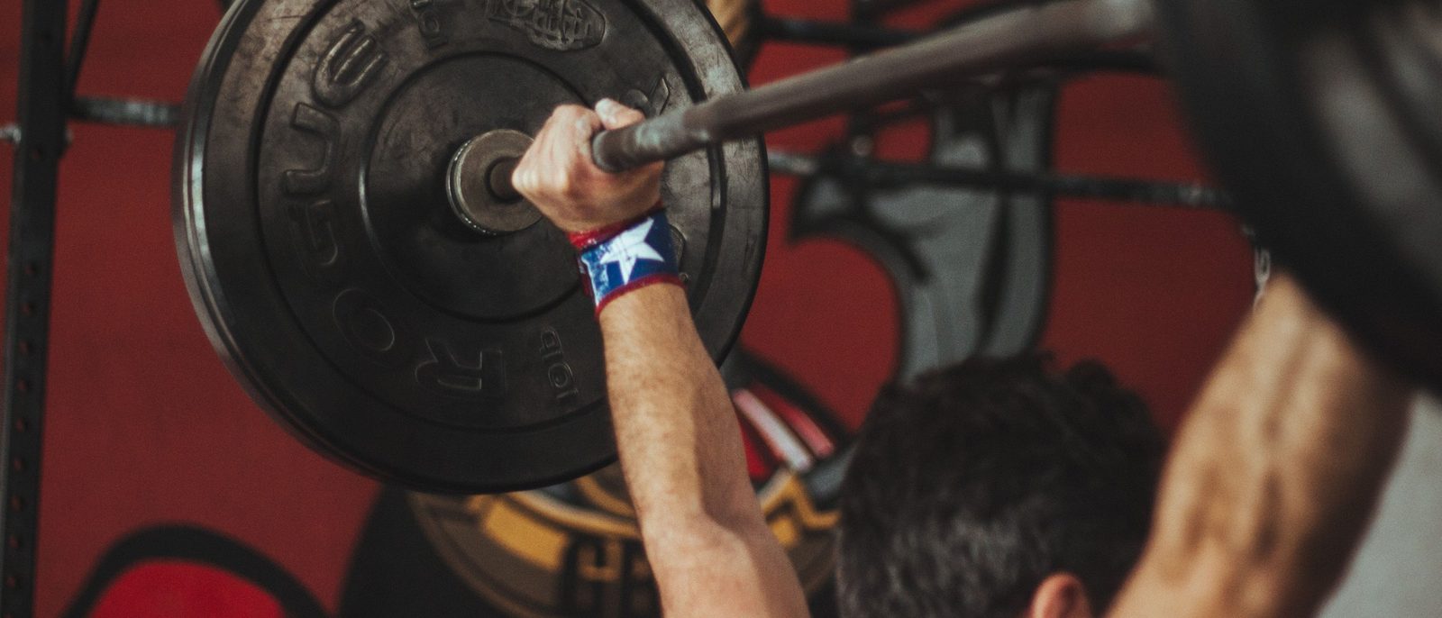 Lifter pressing a loaded barbell overhead