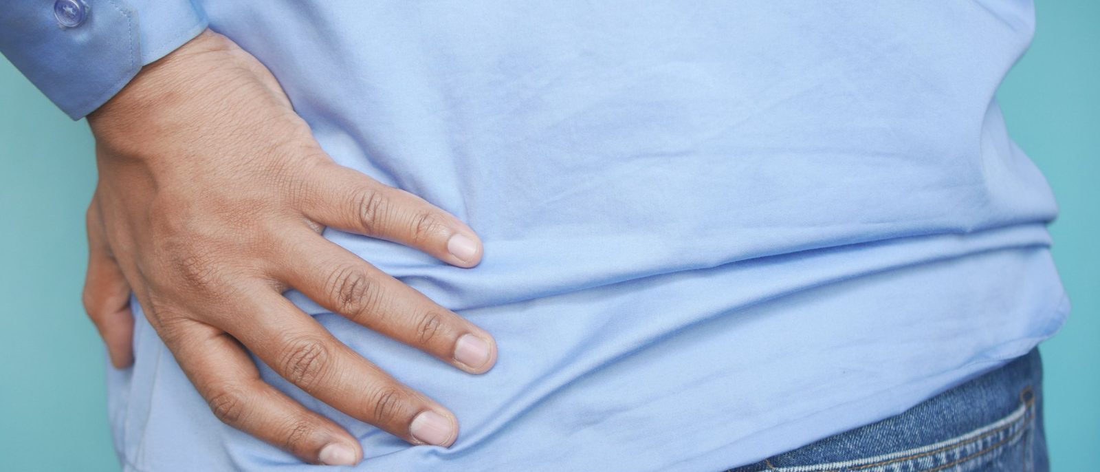 Hand pressed against the side of the hip